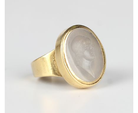 A gold and chalcedony oval intaglio ring, engraved with a portrait, unmarked, weight 13g, ring size approx P.Buyer’s Premium 