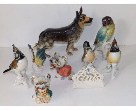 A Goebel porcelain alsatian, 7" high and seven various small animal figures. (8)