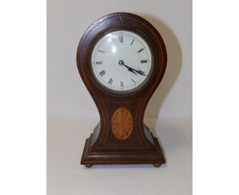 An early 20thC inlaid mahogany waisted balloon shaped mantel clock, the French drum movement behind convex white enamel dial,