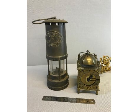 E Thomas & Williams Ltd minors lamp together with brass ornate smiths electric alarm clock 