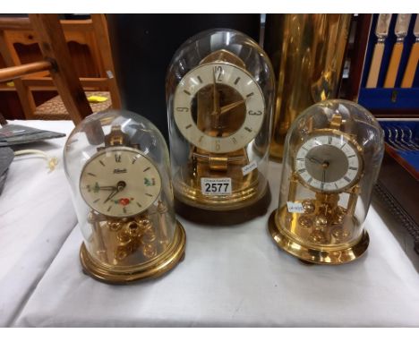 3 Anniversary clocks under glass domes COLLECT ONLY&nbsp;&nbsp;Small clock on right has broken spring, no key.&nbsp; Small cl