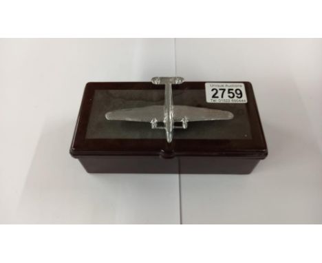 A vintage Bakelite cigarette box with surmounted white metal aeroplane and contents 17cm x 8.5cm x 6cm