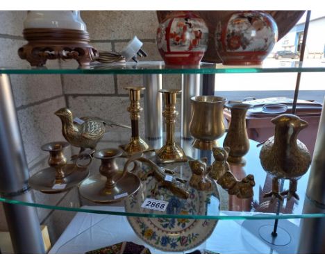 A shelf of brassware including Partridge teddy bears candlesticks 