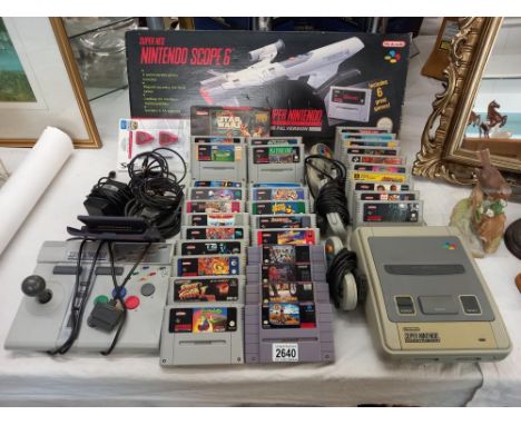 A Super Nintendo console, boxed Scope 6 and quantity of games etc.  Collect Only 