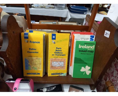 An oak book rack and quantity of vintage maps Collect only 