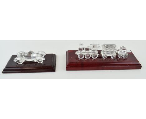 Swarovski steam train to include engine, a carriage and a similar piece with a Swarovski car, both on wooden base (2).  In go