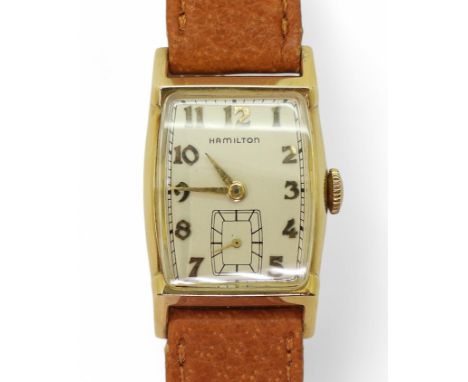 A HAMILTON WRISTWATCH the case made in 10k gold, with silvered dial, gold coloured Art Deco style Arabic numerals and hands, 