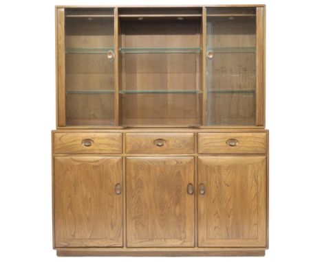 A 20TH CENTURY ERCOL ELM AND BEECH "WINDSOR" SIDEBOARD&nbsp; top with pair of glazed doors flanking two open glazed shelves o