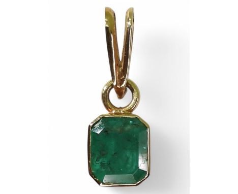 EMERALD PENDANTA bright yellow metal mounted emerald pendant. Set with a step cut emerald of estimated approx 6.5mm x 7.5 x 4