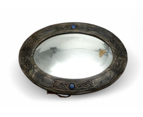A SCOTTISH SCHOOL ARTS AND CRAFTS PEWTER MIRROR the oval frame with Celtic knotwork design and with two pale blue ceramic rou