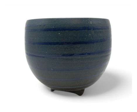 DAVID LLOYD JONES (1928-1994) A LARGE STUDIO POTTERY BOWL glazed in blue with ribbed detail, upon three feet, stamped LJ to s