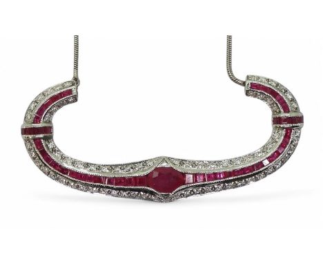 A RUBY &amp; DIAMOND NECKLACE with a central oval cut ruby of approx 7mm x 5mm , with further mixed cut rubies enhanced with 