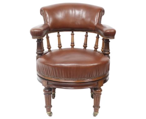 A LATE 19TH MAHOGANY FRAMED CAPTAINS SWIVEL DESK CHAIR&nbsp; with brown Rexine upholstered back and seat on swivel back with 