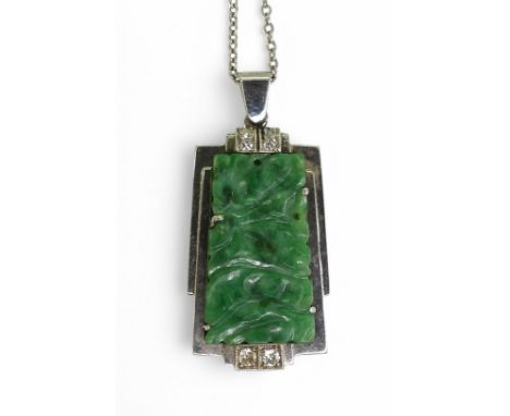 AN ART DECO PENDANT set with four diamonds and a carved green hardstone panel, length including the bail 3.5cm, on a 64cm, fi