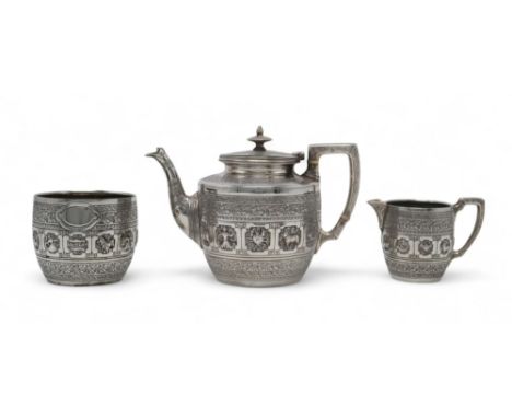 A VICTORIAN ZODIAC PATTERN SCOTTISH SILVER TEA SERVICE by Aird &amp; Thomson, Glasgow, the teapot 1887, the sugar bowl and cr