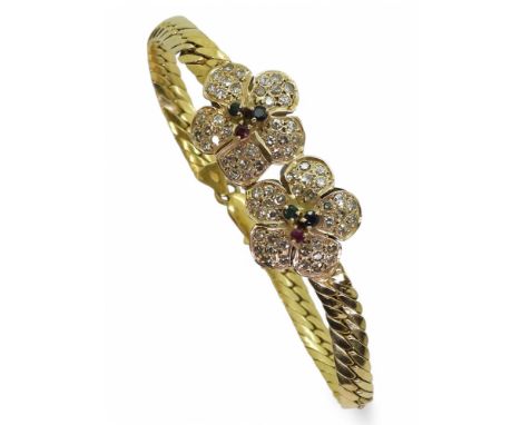 AN ITALIAN FLOWER BRACELET made in 18k gold stamped 750 and Italy to the chain ends. The flower motifs are set with ruby, eme