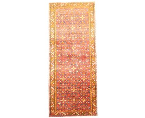 A DARK BLUE GROUND HAMADAN RUNNER with all over geometric multicoloured design within multicolour geometric border, 287cm lon