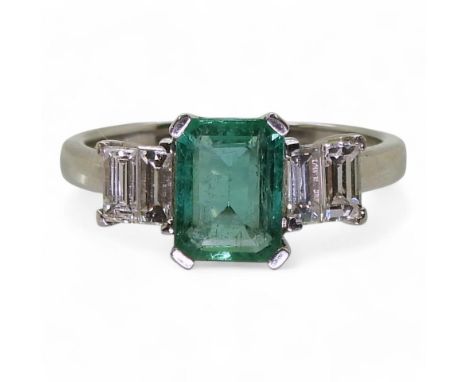 AN 18CT WHITE GOLD CLASSIC STEP CUT EMERALD AND BAGUETTE CUT DIAMOND RING the emerald measures 7.9mm x 5.9mm x 3.5mm, with fo