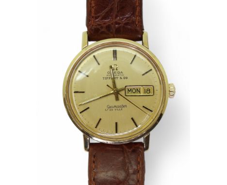 A TIFFANY OMEGA SEAMASTER the gold coloured dial with gold baton numerals and hands, is signed Tiffany &amp; Co, Omega Automa