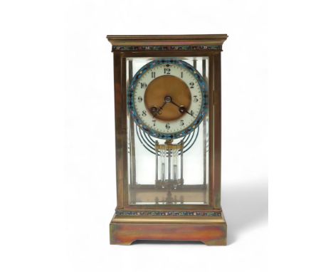 A FRENCH CHAMPLEVE ENAMEL CLOCK with brass and glass case, the dial with white enamel chapter ring with Arabic numerals surro