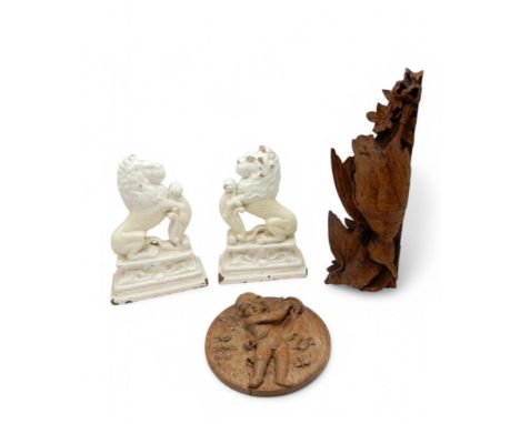 A LATE 18TH/ EARLY 19TH CENTURY CARVED WOODEN PANEL of circular form, carved with a cherub playing a tambourine, 22cm diamete