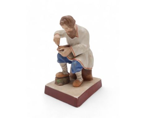 A RUSSIAN GARDNER FACTORY BISQUE FIGURE late 19th century, modelled as a Lapti Plaiter (Bast Shoemaker), with printed and imp