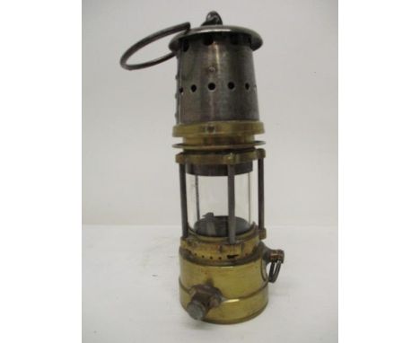 A Patterson Lamps Co Ltd Type Gt baby brass and polished metal minors safety lamp with a clear glass panels and manufacturers