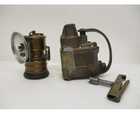 A Premier Lamp & Eng Co Ltd brass and metal acetylene lamp, 4 1/2" h and a brass and metal single shot Lt exploder, the side 