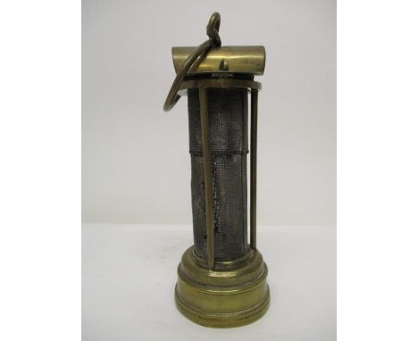 A Laidler Davy type brass and gauze minors safety lamp with a hinged top, stamped with the manufacturer and JS , 7 1/2" h 