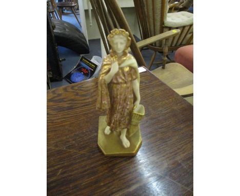 A late 19th century Royal Worcester gilt figure of a woman holding a basket 