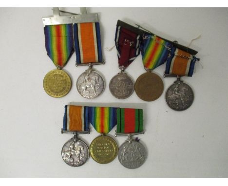 Three groups of WW I and WW II medals comprising a British war a Victory and a Defence inscribed 14240 PTE W H Hill MGC,, a B