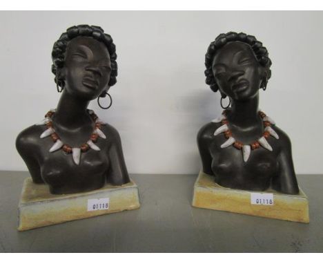 A pair of Leopold Anzengruber, Austrian pottery bookends, busts of Negro women, each modelled wearing a tooth necklace and me
