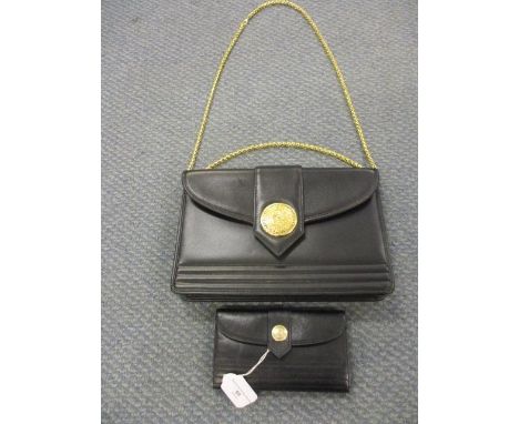 A vintage Yves Saint Laurent leather shoulder bag with gilt chain handle and central gilt button motif to the clasp, together