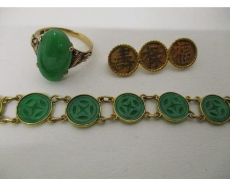 Chinese gold jewellery comprising an 18ct gold bracelet made from twelve carved and pierced jade roundels, an 18ct gold ring 