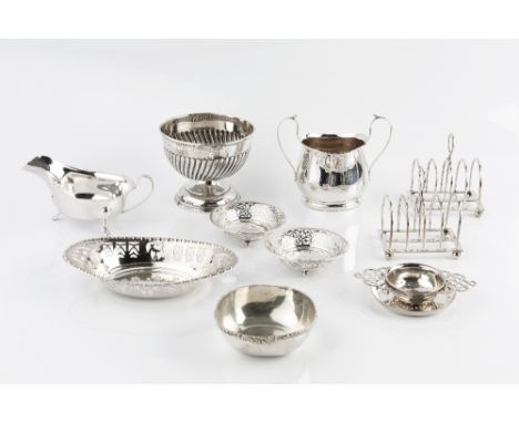 A GROUP OF SILVER, comprising a pair of Edwardian five bar toast racks by William Hutton &amp; Sons Ltd, London 1903, a pedes