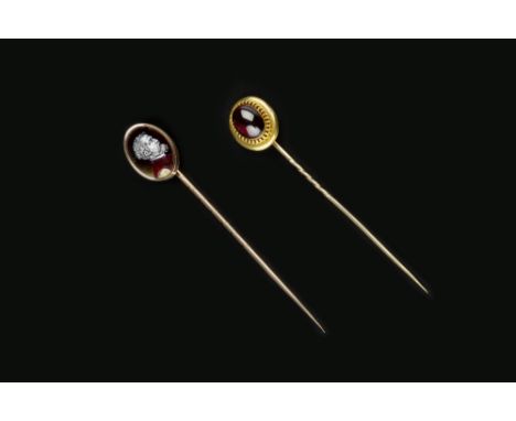 A SMALL COLLECTION OF STICK PINS, comprising a cabochon garnet single stone stick pin, (later fitting), a coral corallium rub