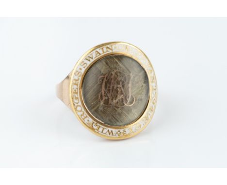 A GEORGIAN ENAMEL AND HAIRWORK MEMORIAL RING, the circular plaited hairwork panel with gilt monogram WRS, bordered by white e