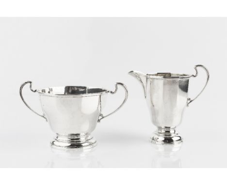 A SILVER TWIN HANDLED SUGAR BASIN, of part faceted design, with matching milk jug, by Roberts &amp; Dore, Birmingham 1939, su