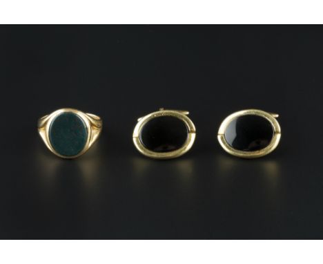 A LATE VICTORIAN BLOODSTONE SIGNET RING, the oval bloodstone panel to an 18ct gold mount, with fluted tapered shoulders, hall