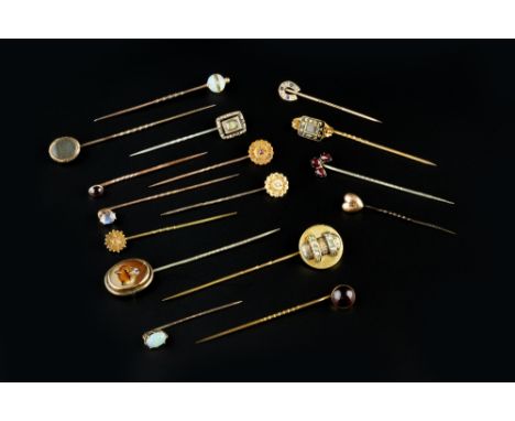 A COLLECTION OF STICK PINS, of assorted design, to include garnet, opal and half pearl set examples, some adapted with later 