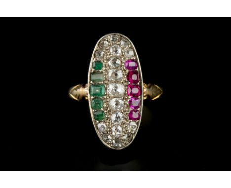 A RUBY, EMERALD AND DIAMOND PANEL RING, the elongated oval panel inset with channels of graduated cushion-shaped rubies, emer