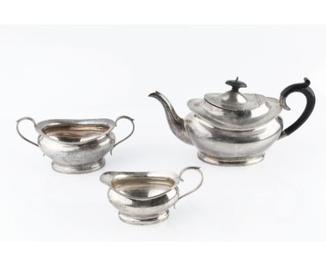 A SILVER THREE PIECE TEA SERVICE, of shaped oval form, the teapot with ebonised handle and knop, by Charles S. Green &amp; Co