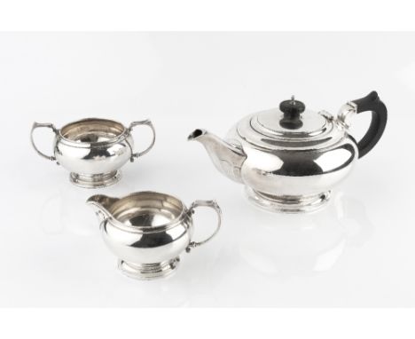 A SILVER THREE PIECE TEA SERVICE, of compressed circular form, the teapot with ebonised handle and knop, by Mappin &amp; Webb