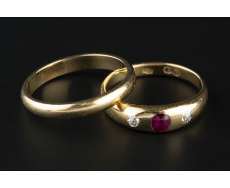 A RUBY AND DIAMOND THREE STONE GYPSY RING, the cushion-shaped ruby and old-cut diamonds to a tapered mount, stamped '18', and