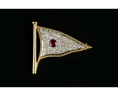 OF MARITIME INTEREST: A RUBY AND DIAMOND PENNANT BROOCH, the flag-shaped panel centred with a circular mixed-cut ruby, to a p