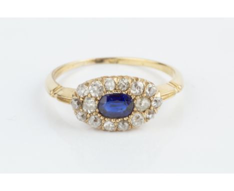 A SAPPHIRE AND DIAMOND PANEL RING, the oval mixed-cut sapphire bordered by graduated old and single-cut diamonds, yellow prec