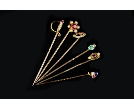 A COLLECTION OF GEM SET STICK PINS, the first modelled as a sword, with an engraved hilt highlighted by single-cut diamonds a