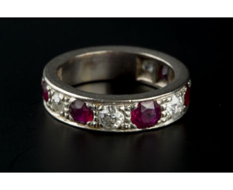 A RUBY AND DIAMOND HALF HOOP RING, alternately set with five graduated circular mixed-cut rubies and six graduated old brilli