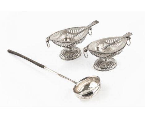 A PAIR OF MID VICTORIAN SILVER NAVETTE SHAPED PEDESTAL SALTS, the pierce decorated sides with embossed swags, twin ring handl