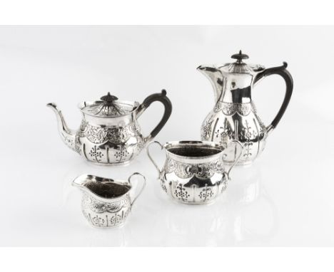 A LATE VICTORIAN SILVER FOUR PIECE TEA SERVICE, comprising teapot, hot water pot, sucrier and milk jug, repoussé decorated an